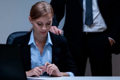 Workplace-sexual-harassment-man-hovers-behind-woman-e1600874742279-700×407