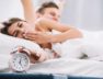 couple-waking-up-near-alarm-clock-with-5am_23-2148027349