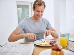 food-eating-breakfast-man-with-newspaper-relax-morning-with-smile-balanced-diet-wellness-home-hungry-person-brunch-healthy-nutrition-with-eggs-bread-bacon-protein_590464-365370