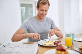 food-eating-breakfast-man-with-newspaper-relax-morning-with-smile-balanced-diet-wellness-home-hungry-person-brunch-healthy-nutrition-with-eggs-bread-bacon-protein_590464-365370