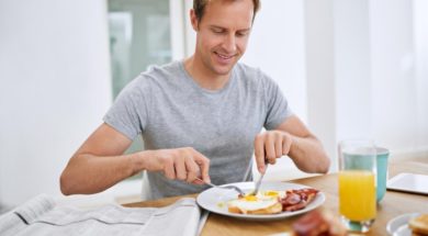 food-eating-breakfast-man-with-newspaper-relax-morning-with-smile-balanced-diet-wellness-home-hungry-person-brunch-healthy-nutrition-with-eggs-bread-bacon-protein_590464-365370