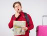 front-view-male-tourist-with-backpack-map-white-wall_179666-28730