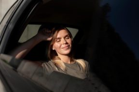 medium-shot-smiley-woman-inside-car_23-2149137197