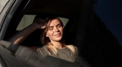 medium-shot-smiley-woman-inside-car_23-2149137197