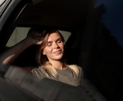 medium-shot-smiley-woman-inside-car_23-2149137197