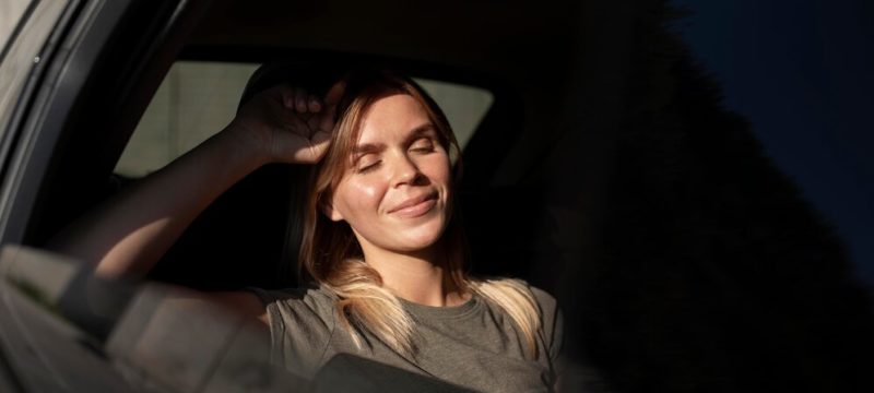 medium-shot-smiley-woman-inside-car_23-2149137197