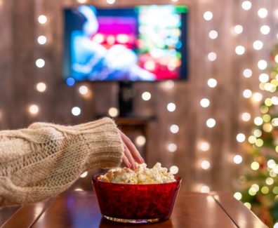 Christmas,Eve.,Alone,Woman,Watching,Tv,And,Eating,Popcorn.,Home