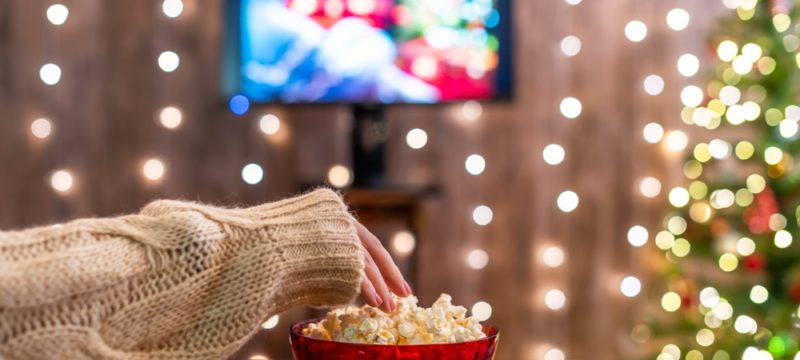 Christmas,Eve.,Alone,Woman,Watching,Tv,And,Eating,Popcorn.,Home